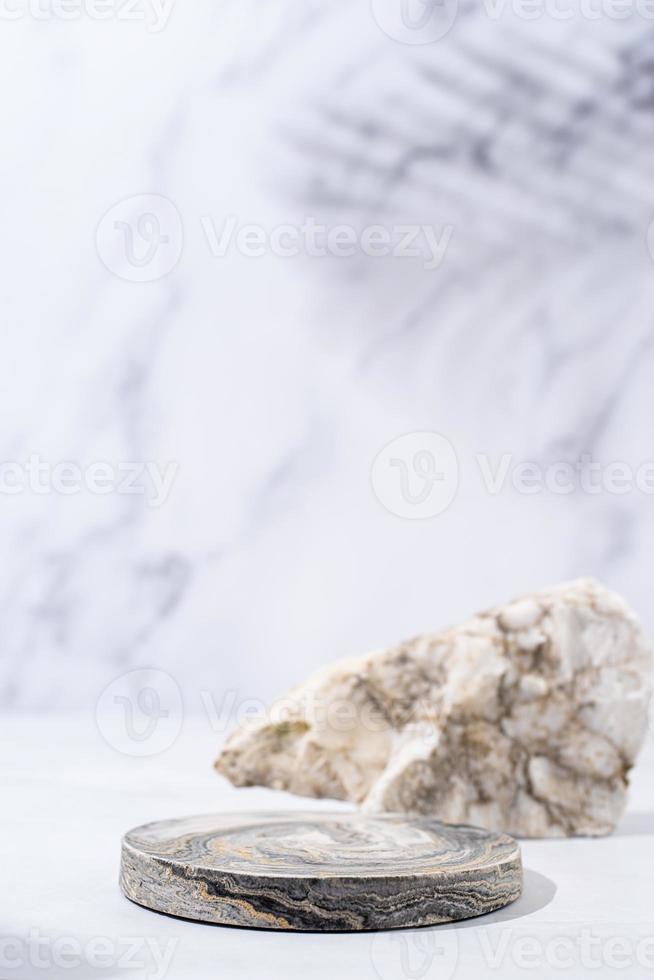 A minimalistic scene of a podium with stones on white background, for natural cosmetics photo