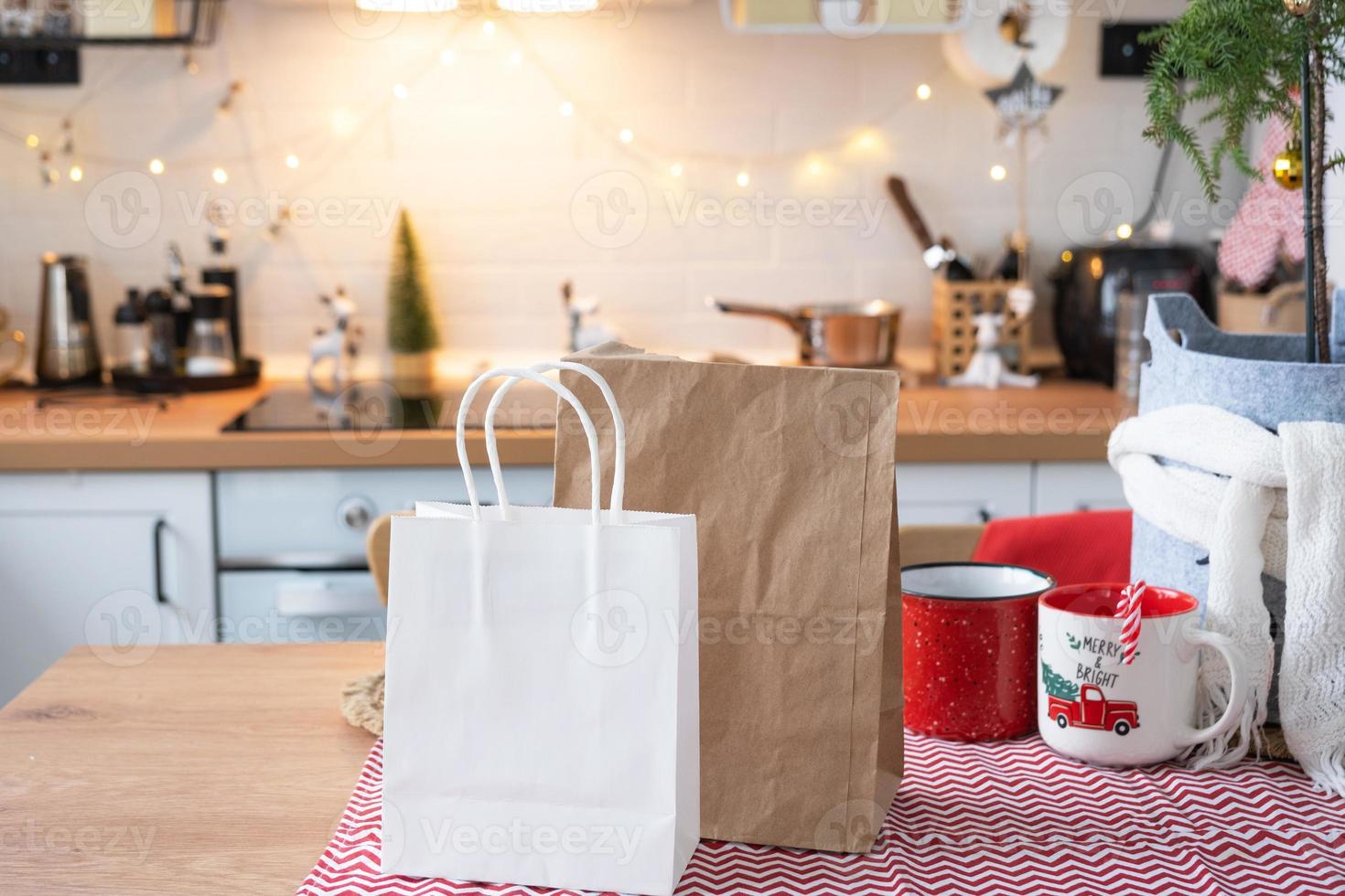 Food delivery service containers on table white scandi festive kitchen in christmas decor. Eve New year, saving time, too lazy to cook, hot order, disposable plastic box in fairy light. mock up photo