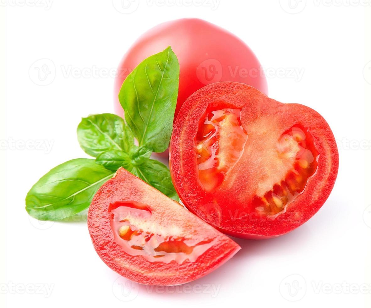 Tomatoes and basil leaves photo