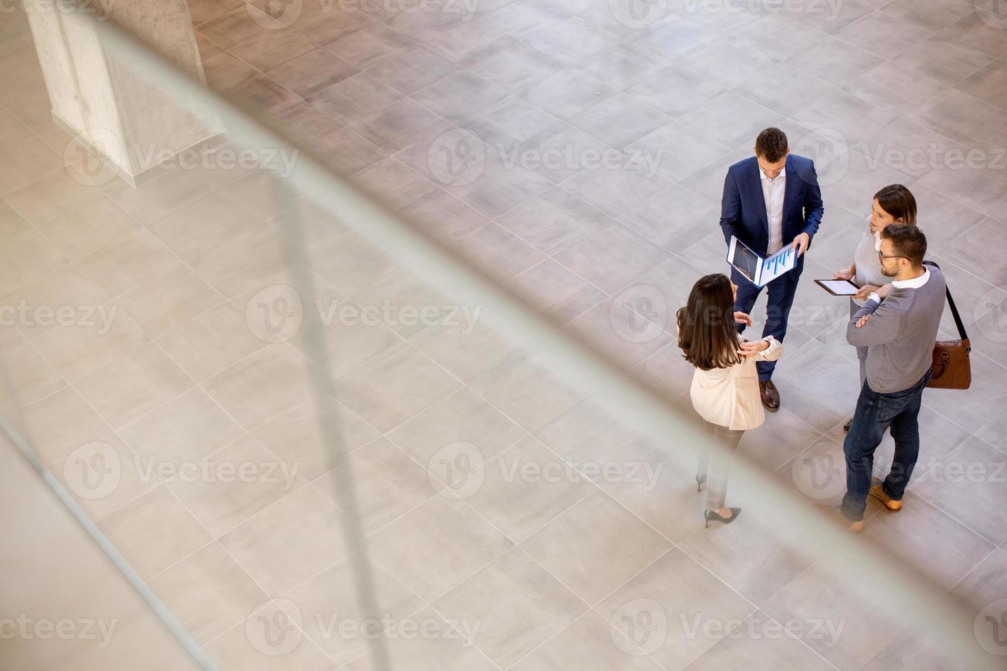 Aerial view at business people team discussing in the office hallway photo