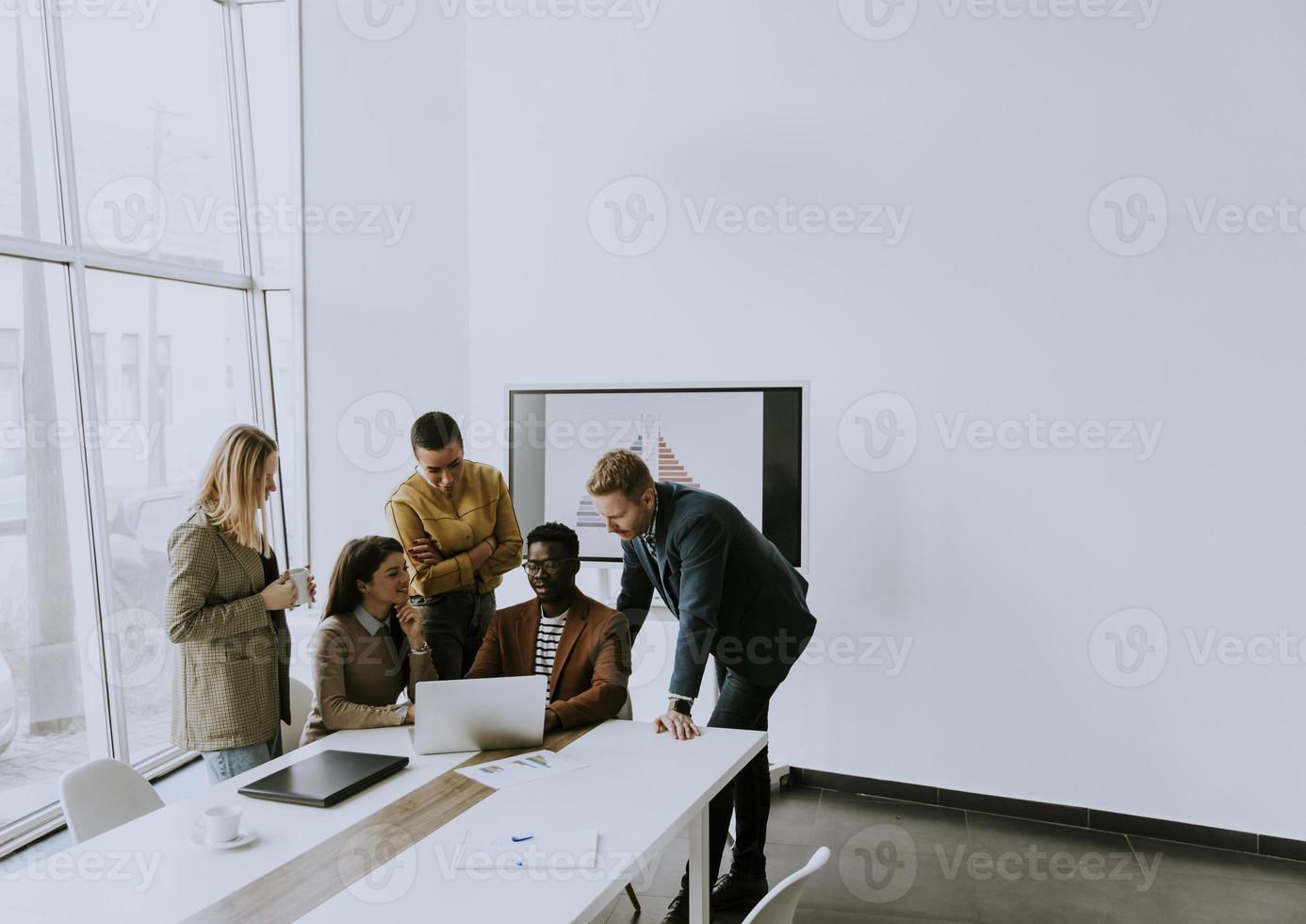 Group of multiethnic business people working together and preparing new project on a meeting in office photo