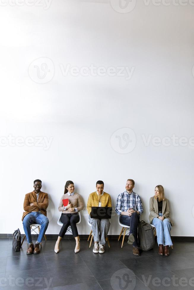 Group of bored people waiting for the job interview photo