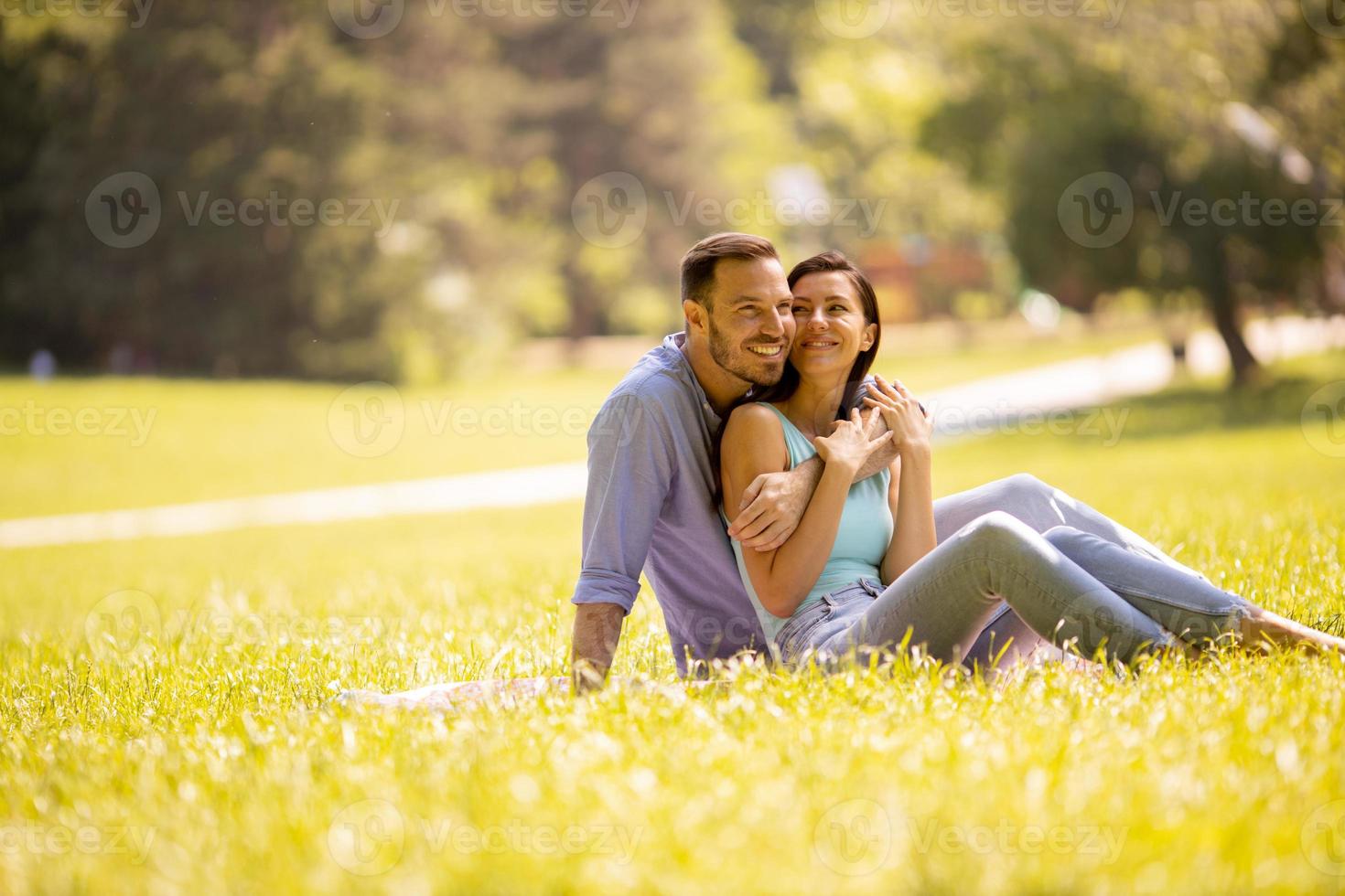 Happy young couple in love at the grass field photo