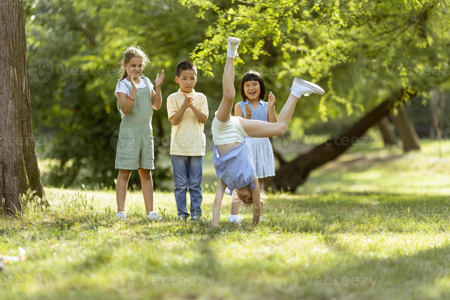 Group of asian and caucasian kids having fun in the park photo