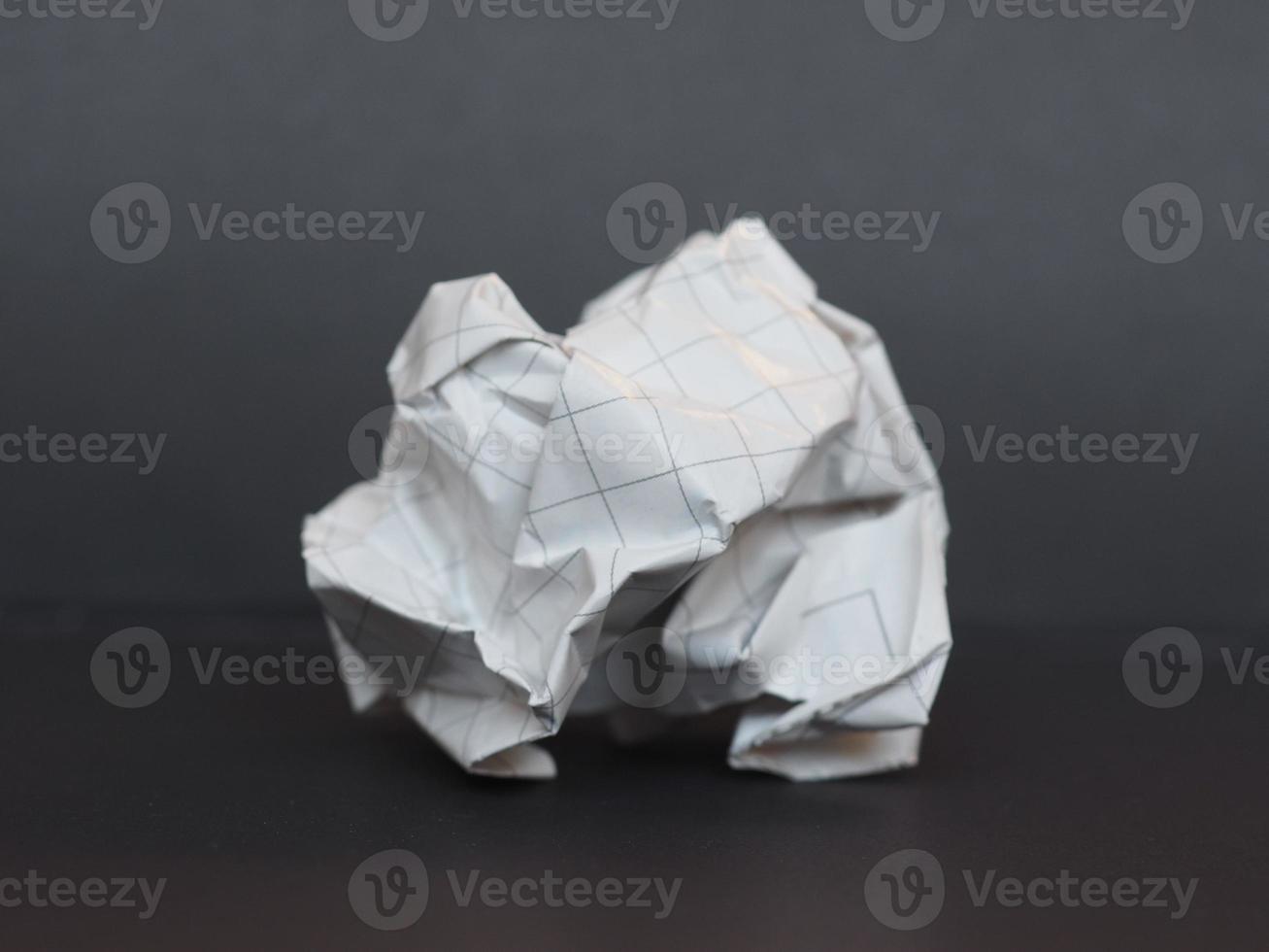 white paper ball over dark gray background photo