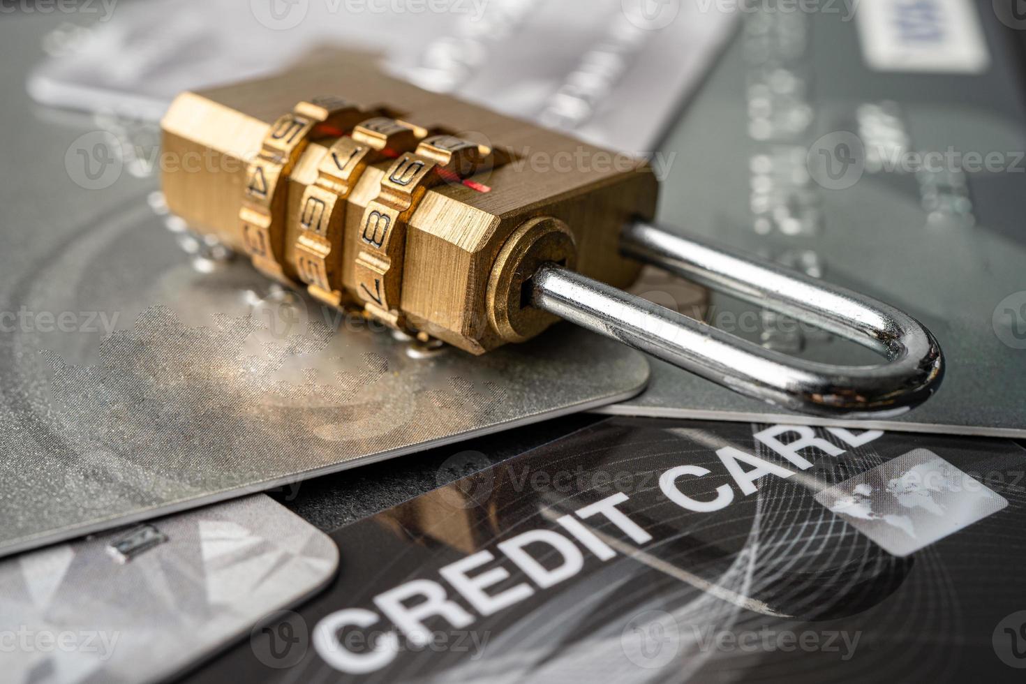 Credit card with password key lock and US dollar banknotes isolated on white background. photo