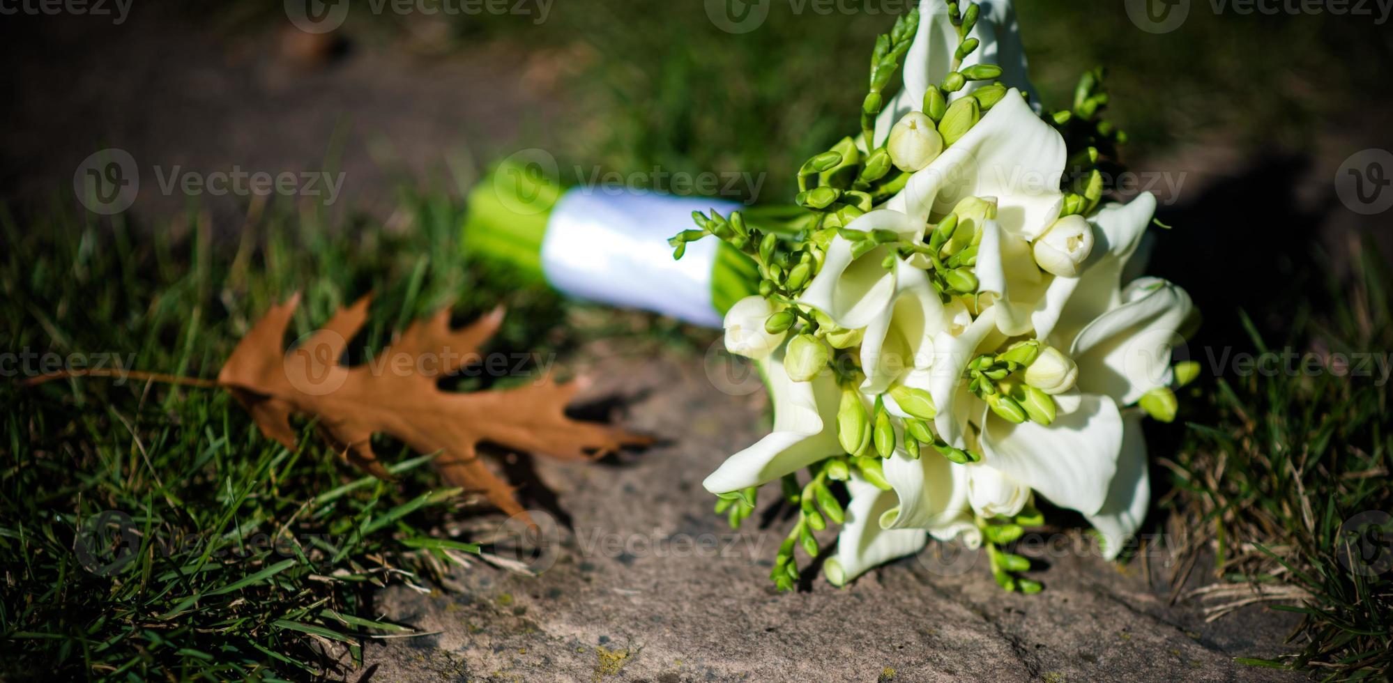 Beautiful decoration of weddings with different exotic green leaves of rees for nature concept set of leaves. Delicate bouquet. Bouquet with roses, peonies, callas for wedding bride and groom photo