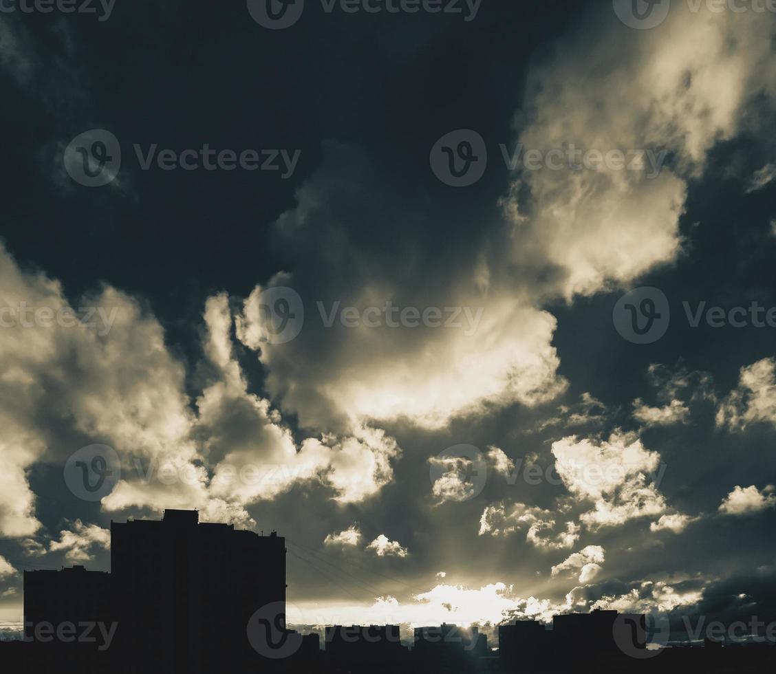 City skyline with dramatic cloudy sky at sunset photo