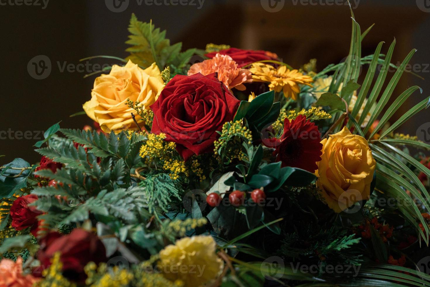 Funeral flowers presented upon a coffin at the event of someone's passing close-up photo