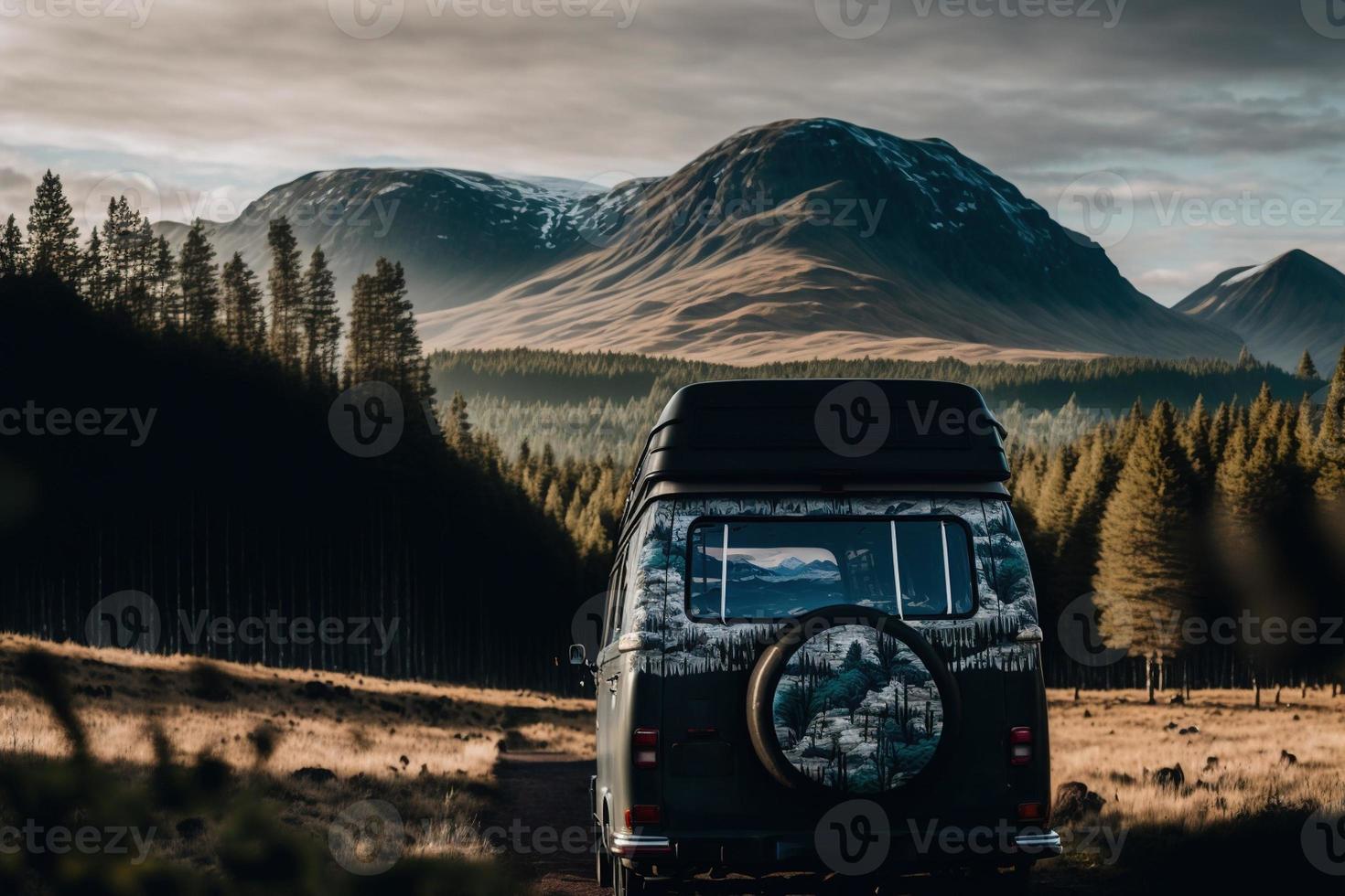 A retro campervan is parked in a beautiful, secluded spot in the great outdoors. It has a small awning and the windows are open, inviting adventurers to explore. The essence of van life. photo