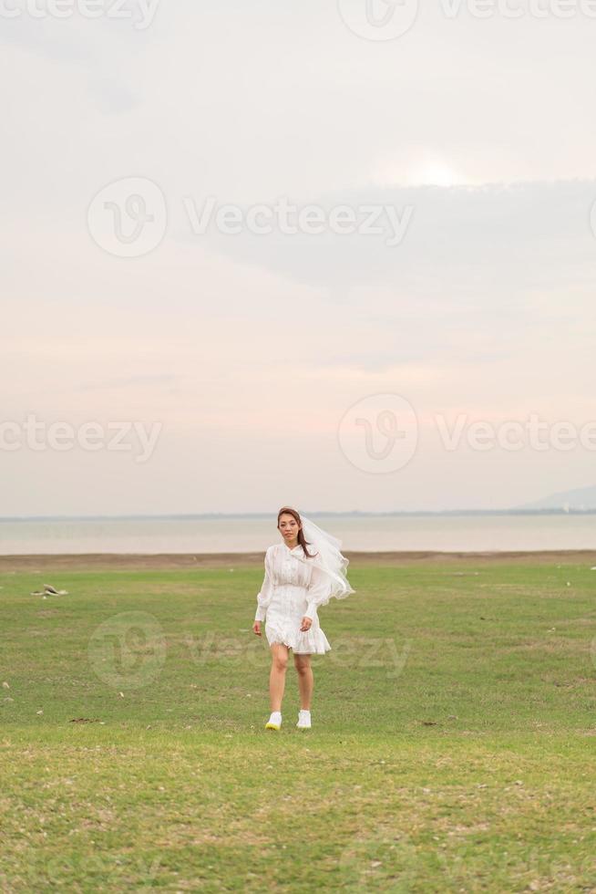 Happy young Asian women in bride clothing with veil photo