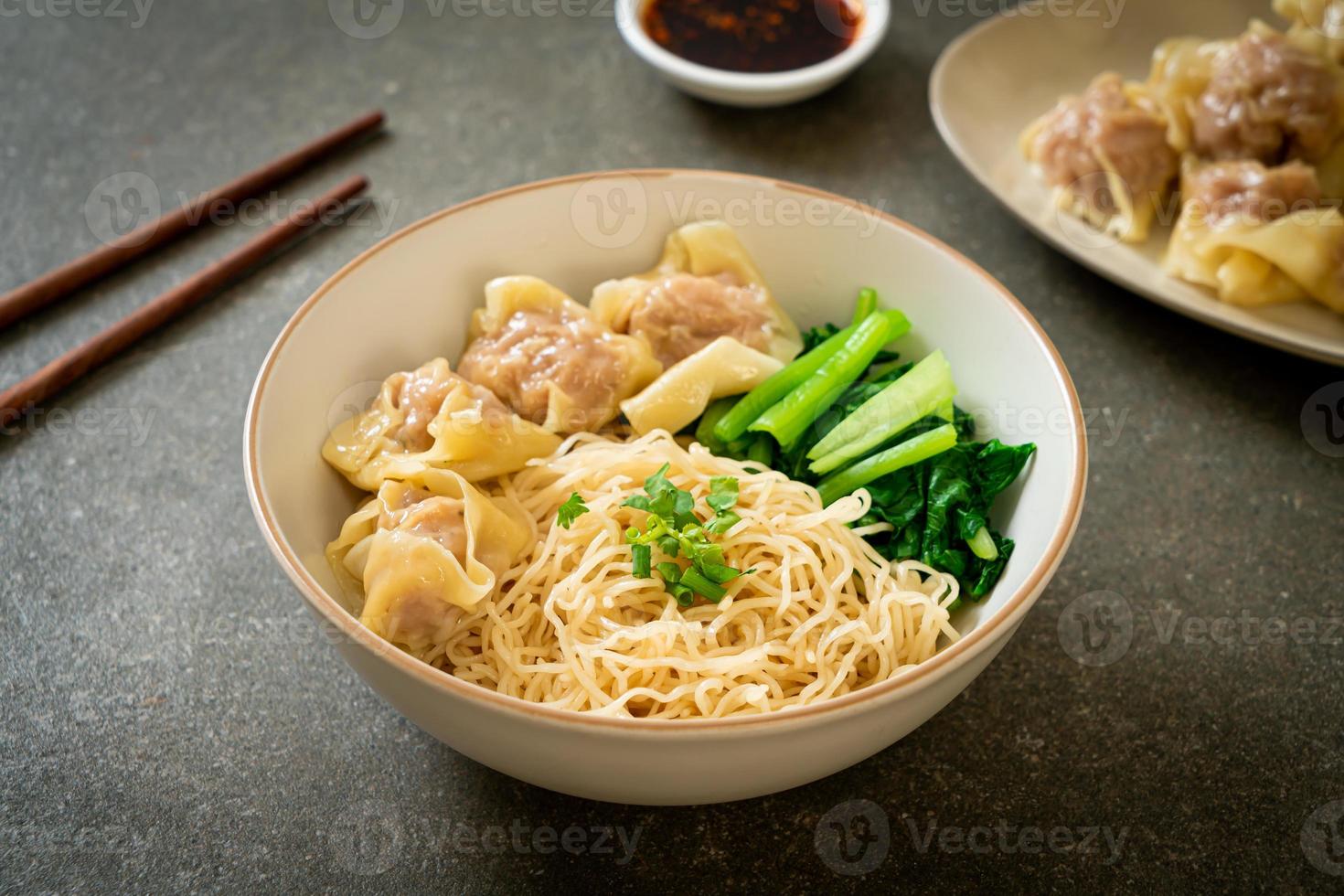 dried egg noodles with pork wonton or pork dumplings without soup photo