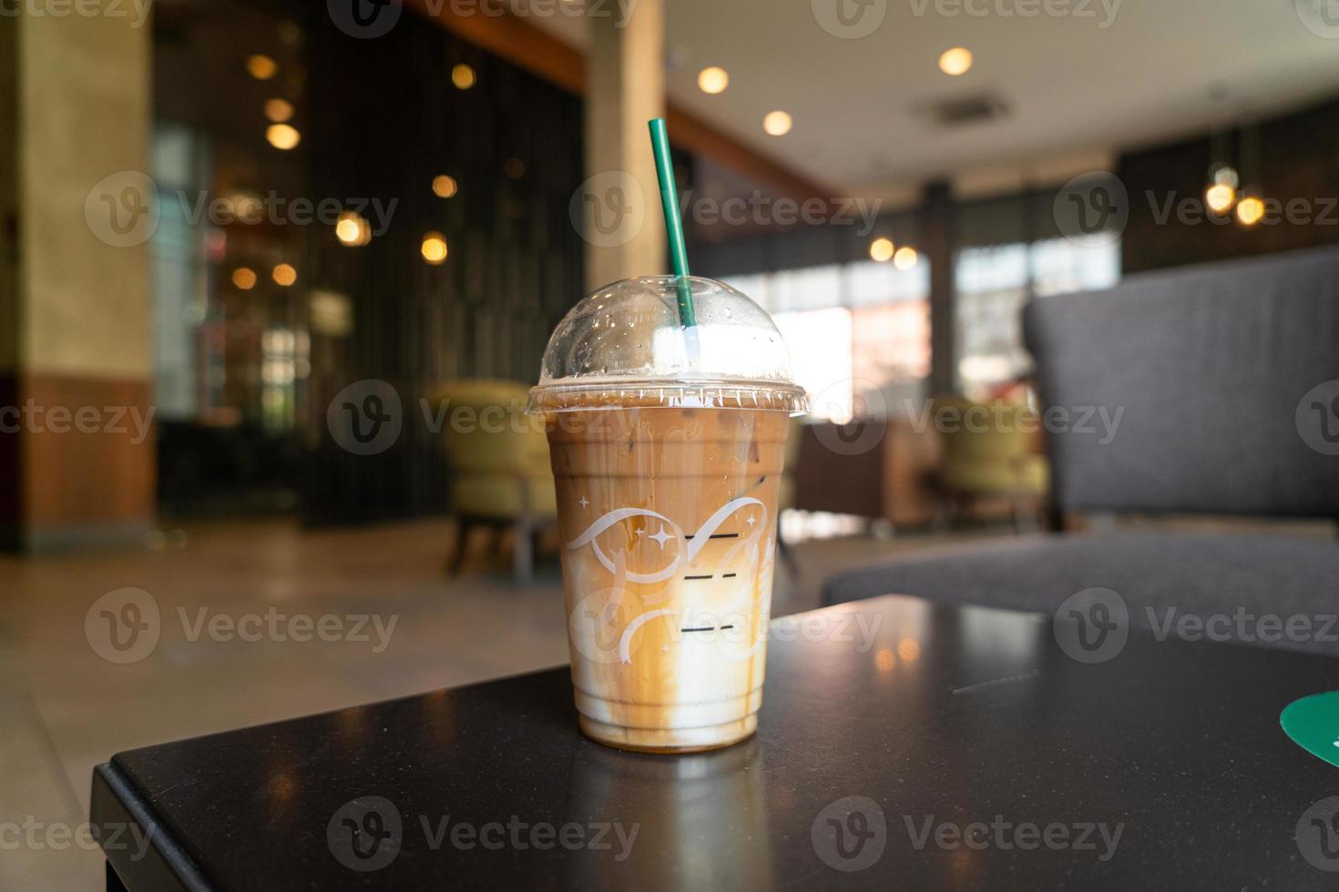 caramel macchiato coffee cup in coffee shop photo