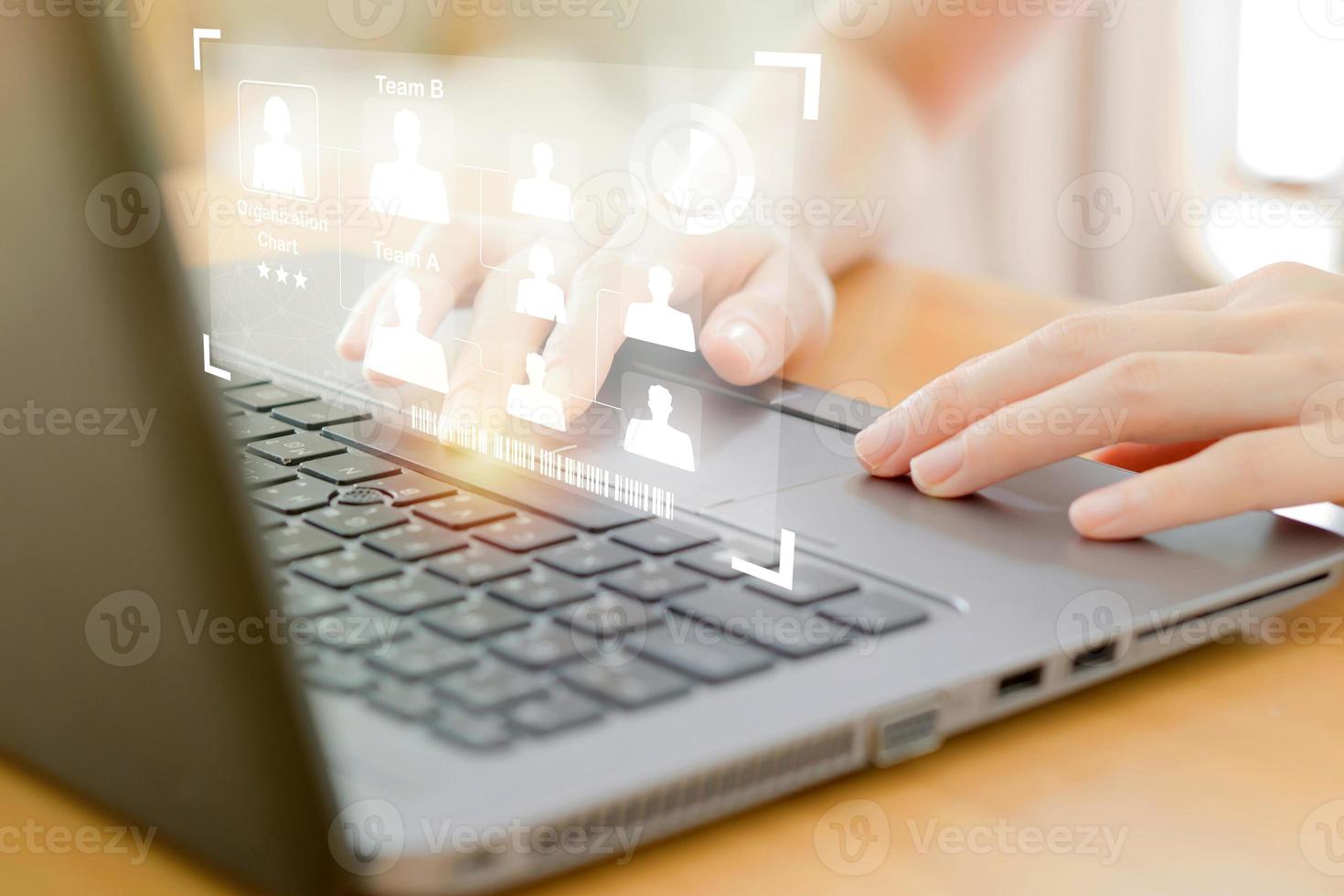 A Businesswoman use laptop for analyze and management team on virtual screen. photo