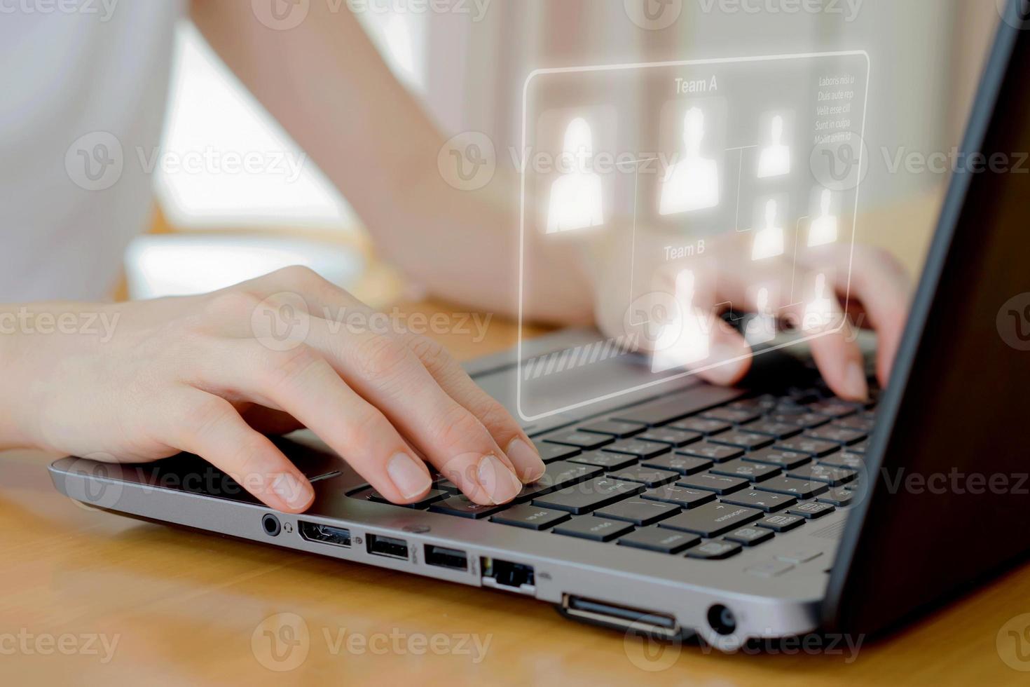 A Businesswoman use laptop for analyze and management team on virtual screen. photo