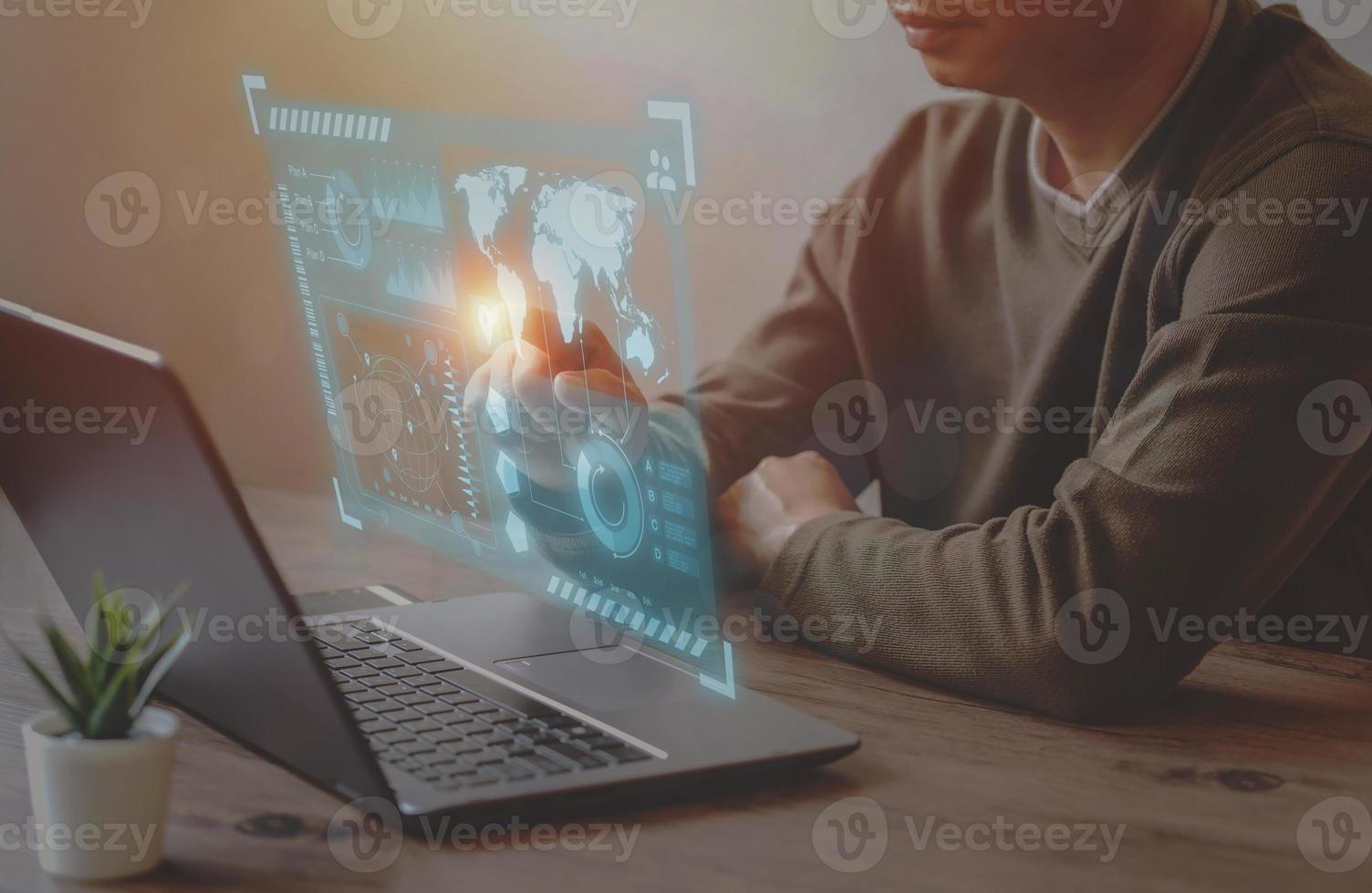 A Businessman use laptop for analyze and management data to succeed on virtual screen. photo