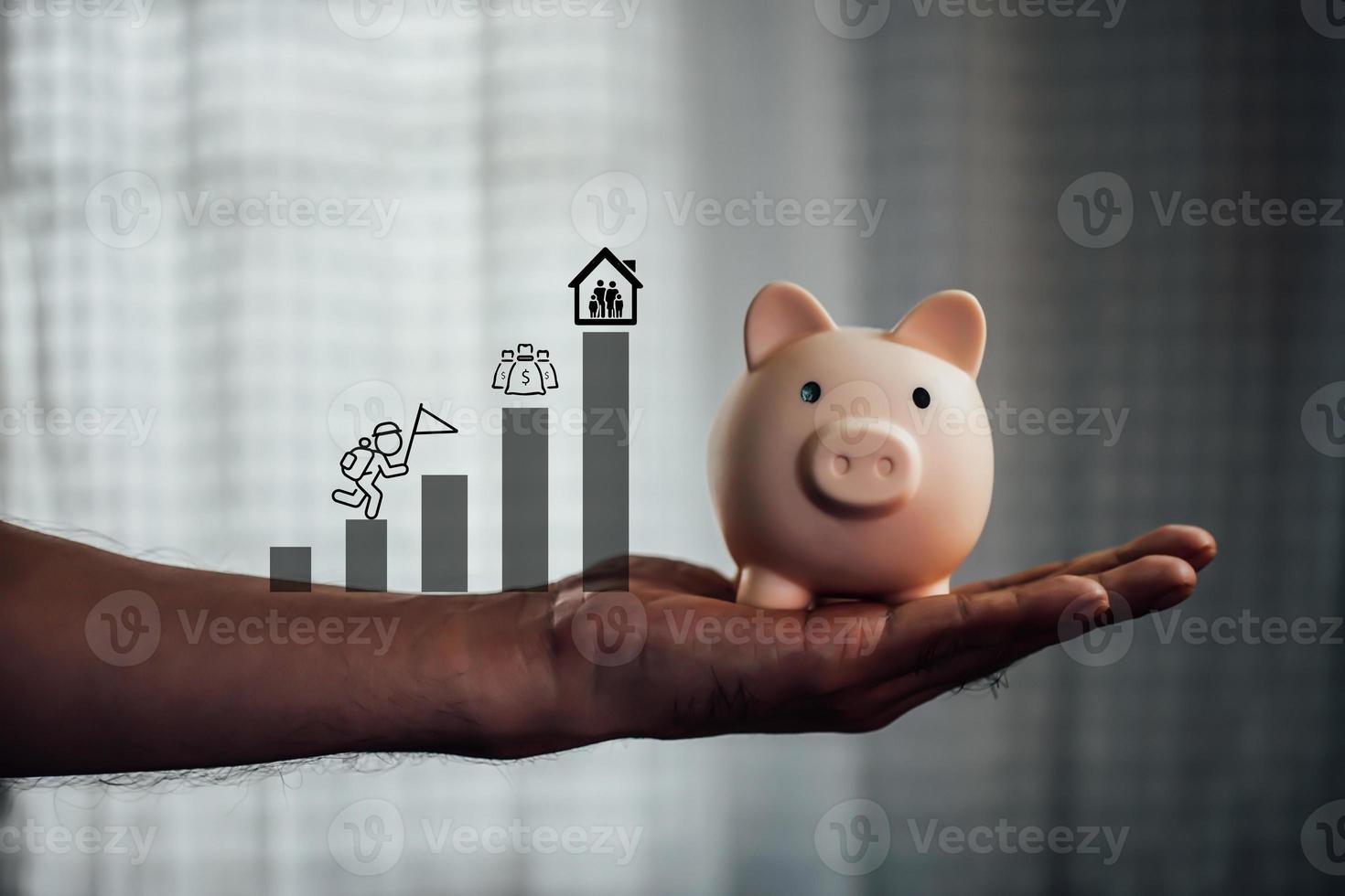 Male hand holding a pink piggy bank. The concept of saving money or savings, investment photo