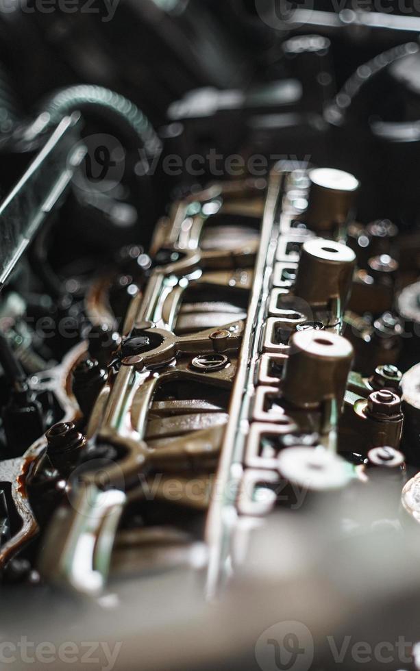 auto mechanic Using Feeler gauge Set the car valve. Measuring valve clearance with tappet feeler gauge set photo
