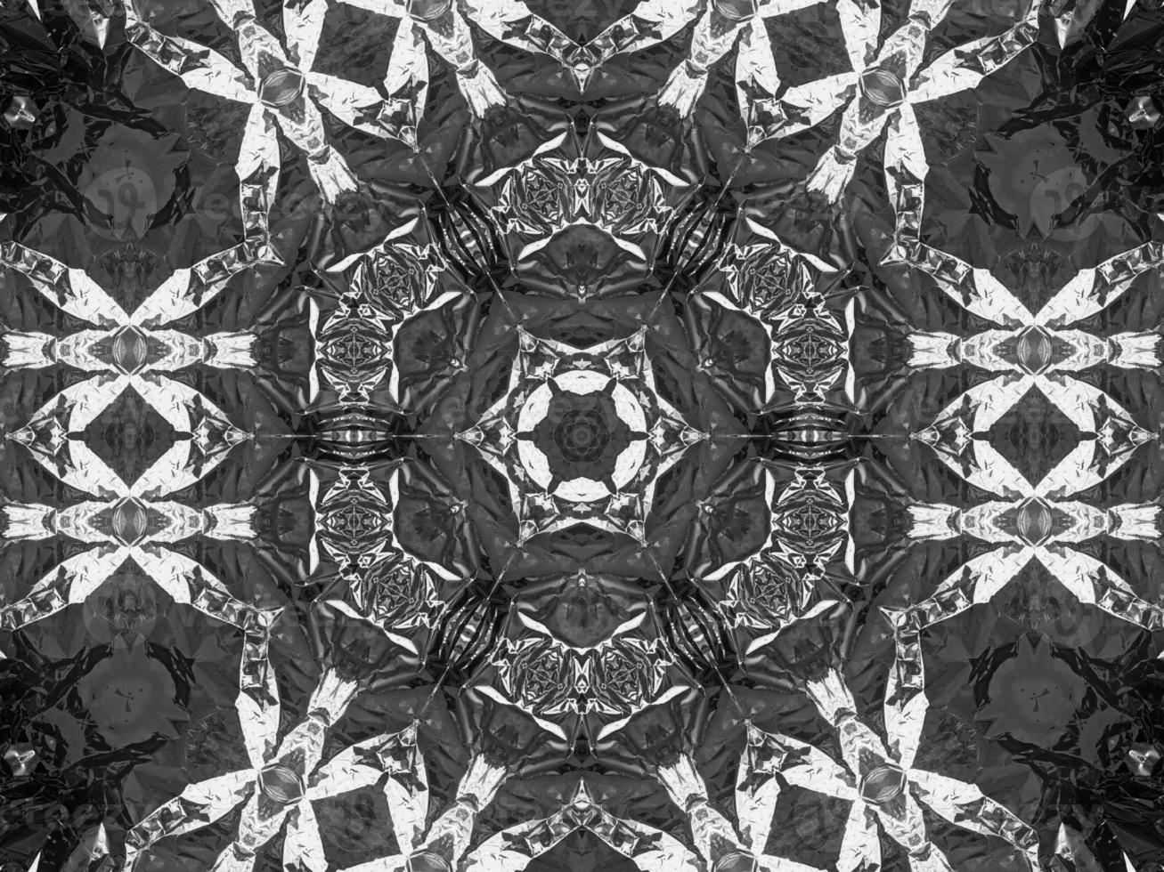 Black silver metalic kaleidoscope background. Abstract and symmetric pattern with dark vibes. photo