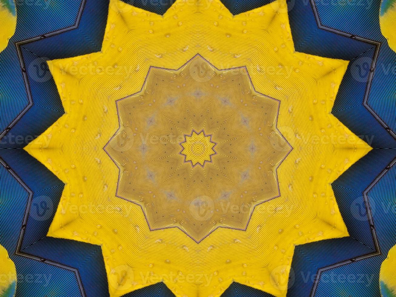 Yellow feather kaleidoscope floral pattern with some blue and red color. Abstract unique and aesthetic background. photo