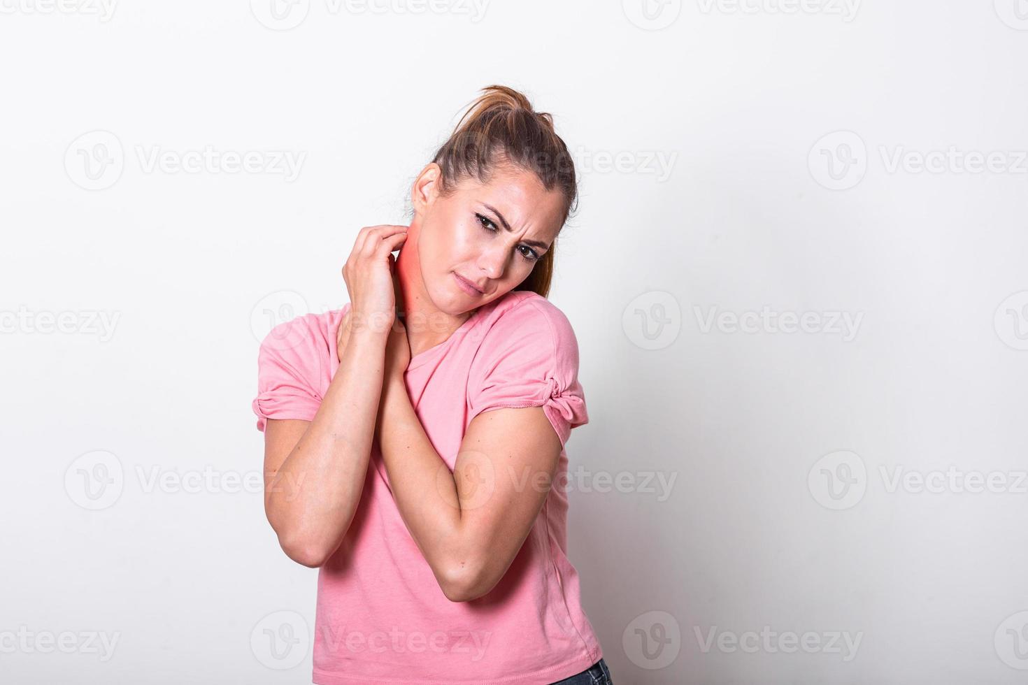 Young woman scratching bitten, red, swollen neck skin from mosquito bites in the summer. Allergy or insect bites. Irritated skin. photo