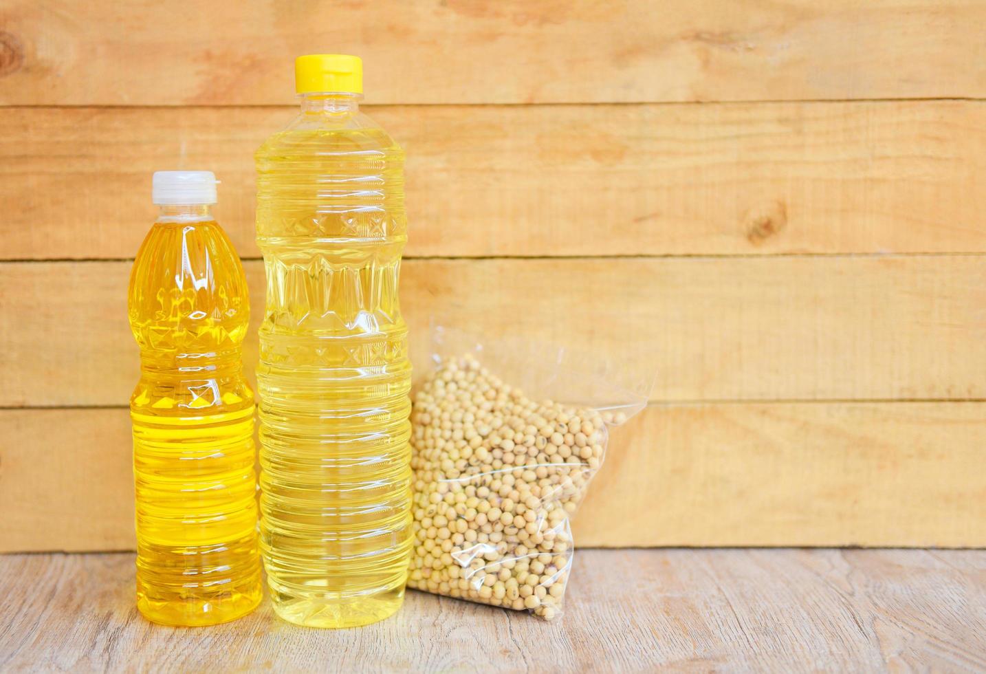 Cooking oil bottle on wooden background Vegetable oil Soybean oil photo