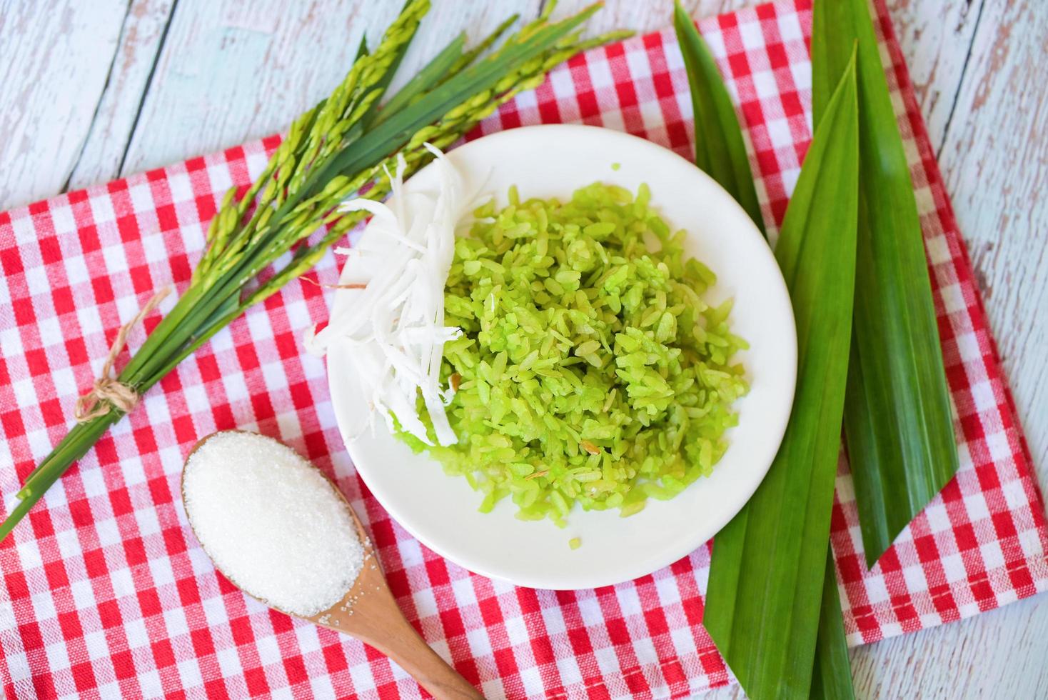 Thai dessert - pounded unripe rice food rice flakes cereal with coconut and sugar, Green rice sweet with ears of rice pandan leaf, Food dessert or snacks - Khao Mao name in Thailand photo