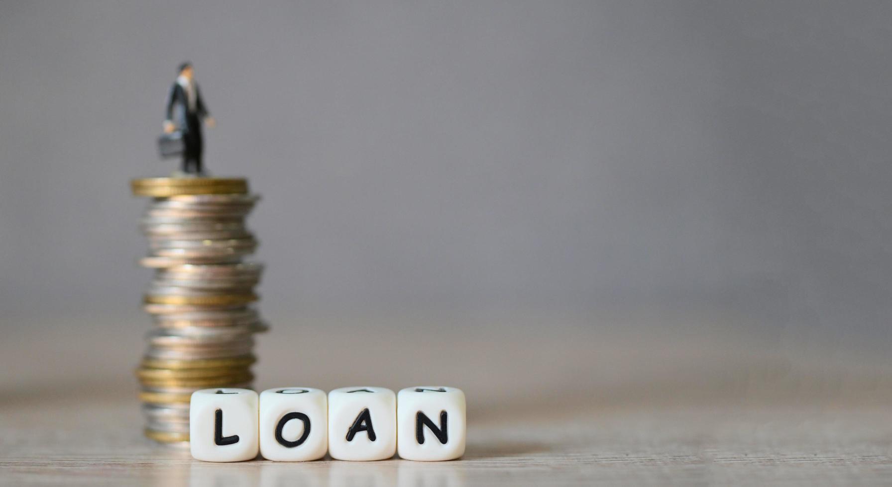 Loan business economy concept of money and finance, on table, Loan business finance economy and business man standing on a coin on wooden table background photo