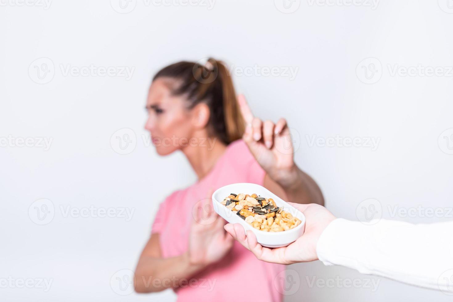 Peanut food allergy concept. Great concept of allergy and skin diseases. Nut allergies. Peanut allergy concept - food intolerance. Young girl refuses to eat peanuts - shallow depth of field photo