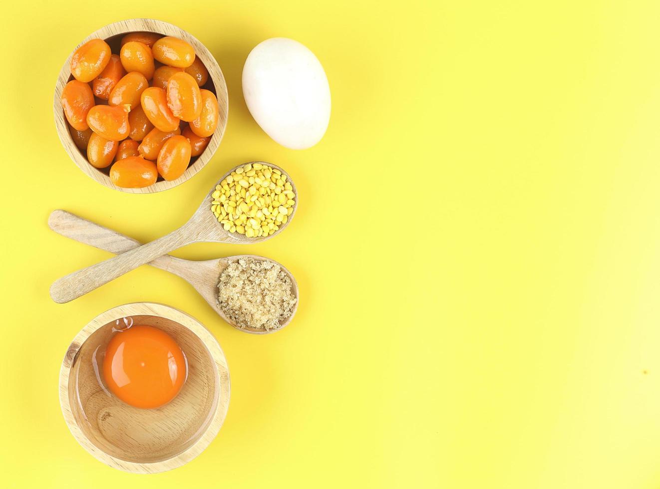 Top view of Thai dessert and ingredient - Mung bean paste formed in egg yolk and sugar on yellow background photo