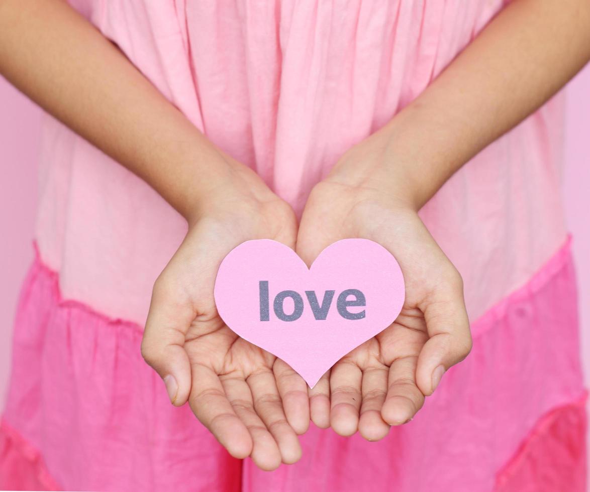 young hands with heart tag of love give love to another photo
