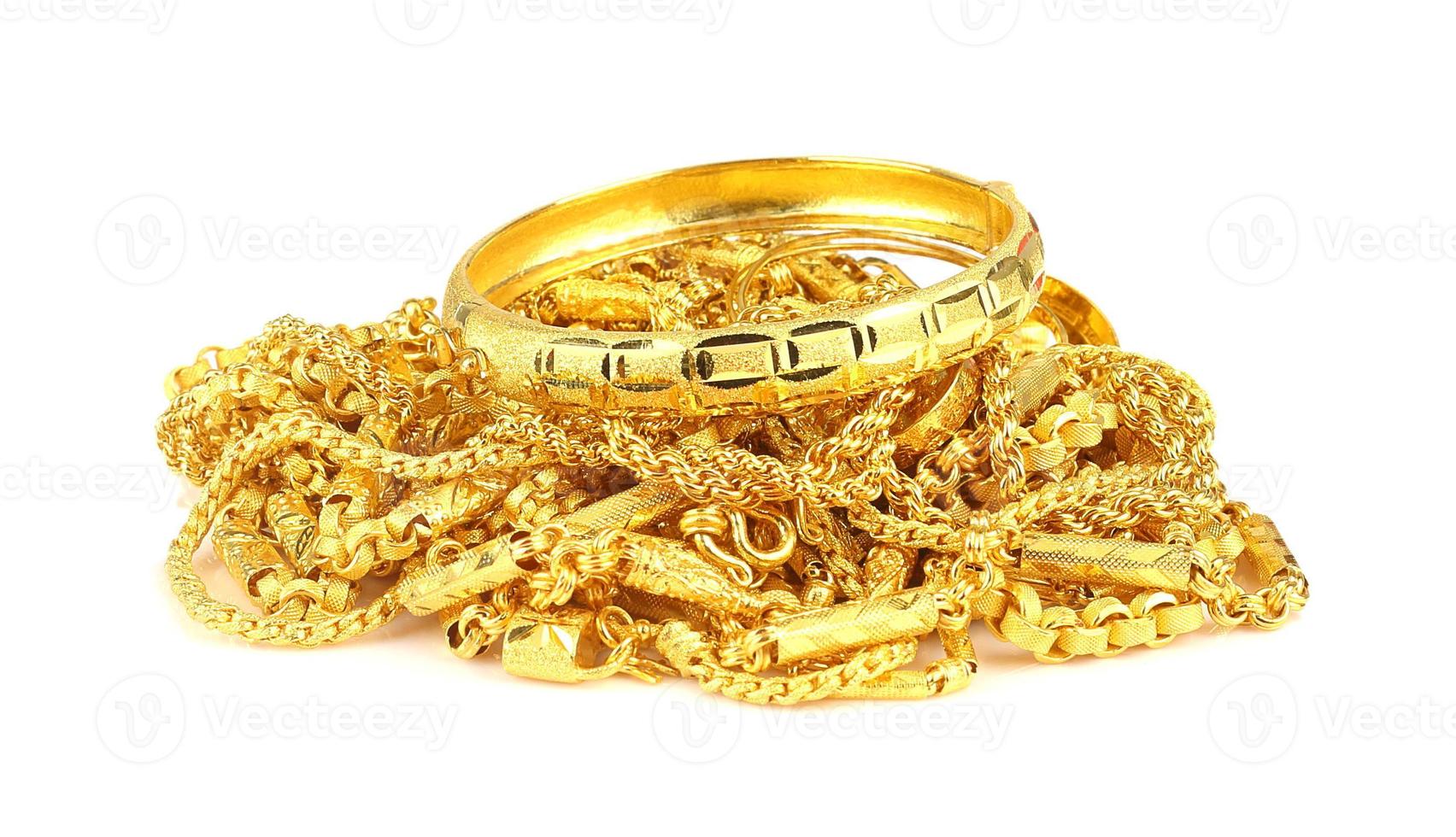 Group of gold jewelry isolated on white photo