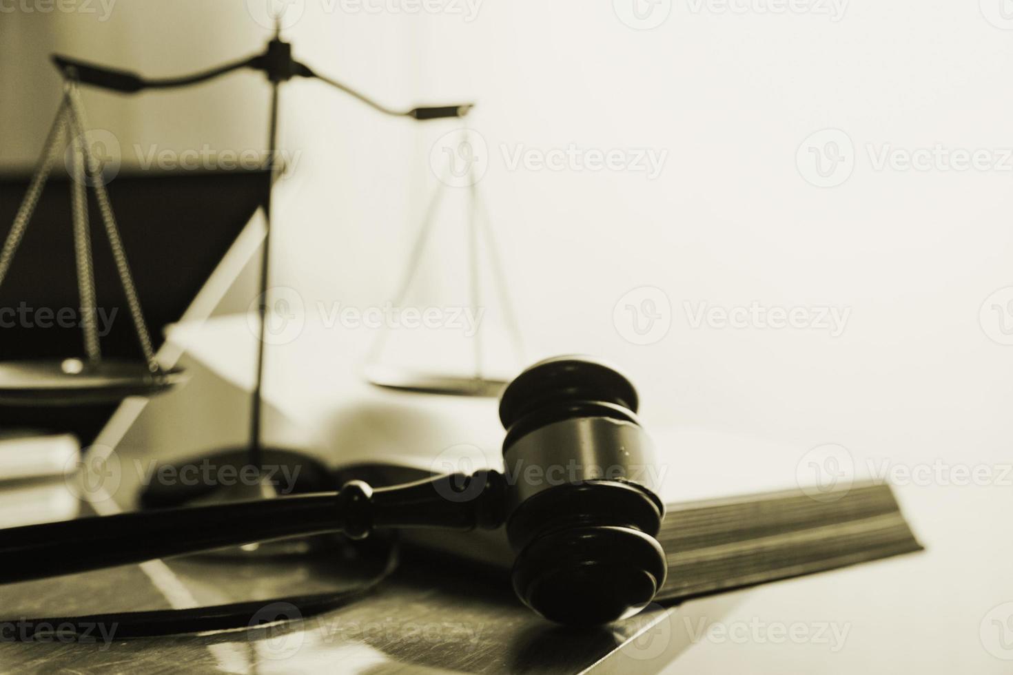 Justice and law concept.Male judge in a courtroom with the gavel, working with, computer and docking keyboard, eyeglasses, on table in morning light photo