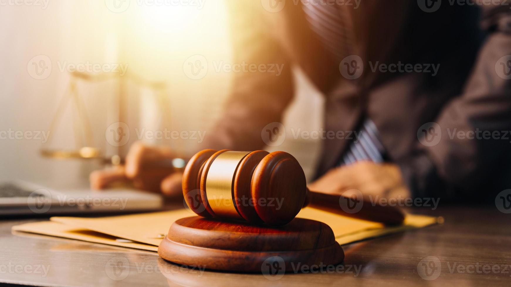 justice and law concept.Male judge in a courtroom on wooden table and Counselor or Male lawyer working in office. Legal law, advice and justice concept. photo