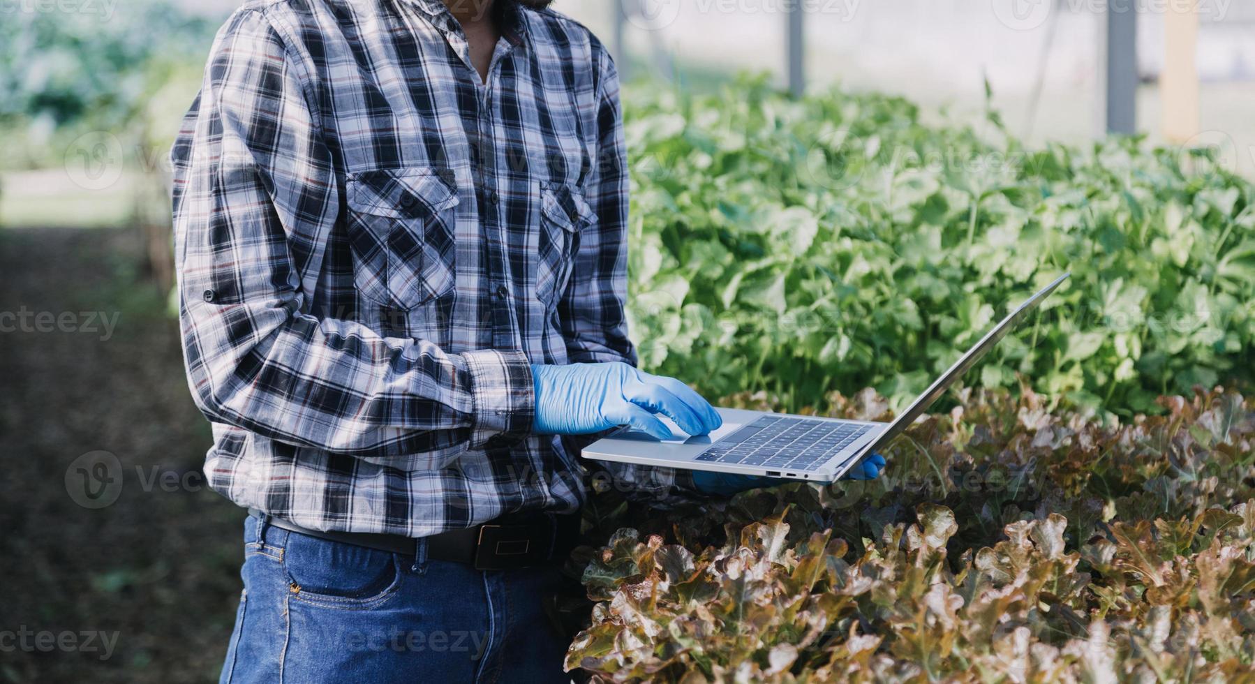 Futuristic businessman farms vegetables and crops using modern AI technology using mobile phones, temperature and humidity sensors, water tracking, climate control, holographic data data icons. photo