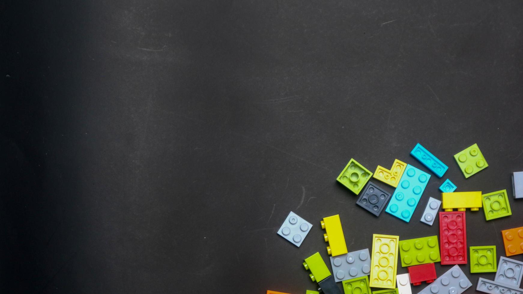 Plastic toy block on a black background photo