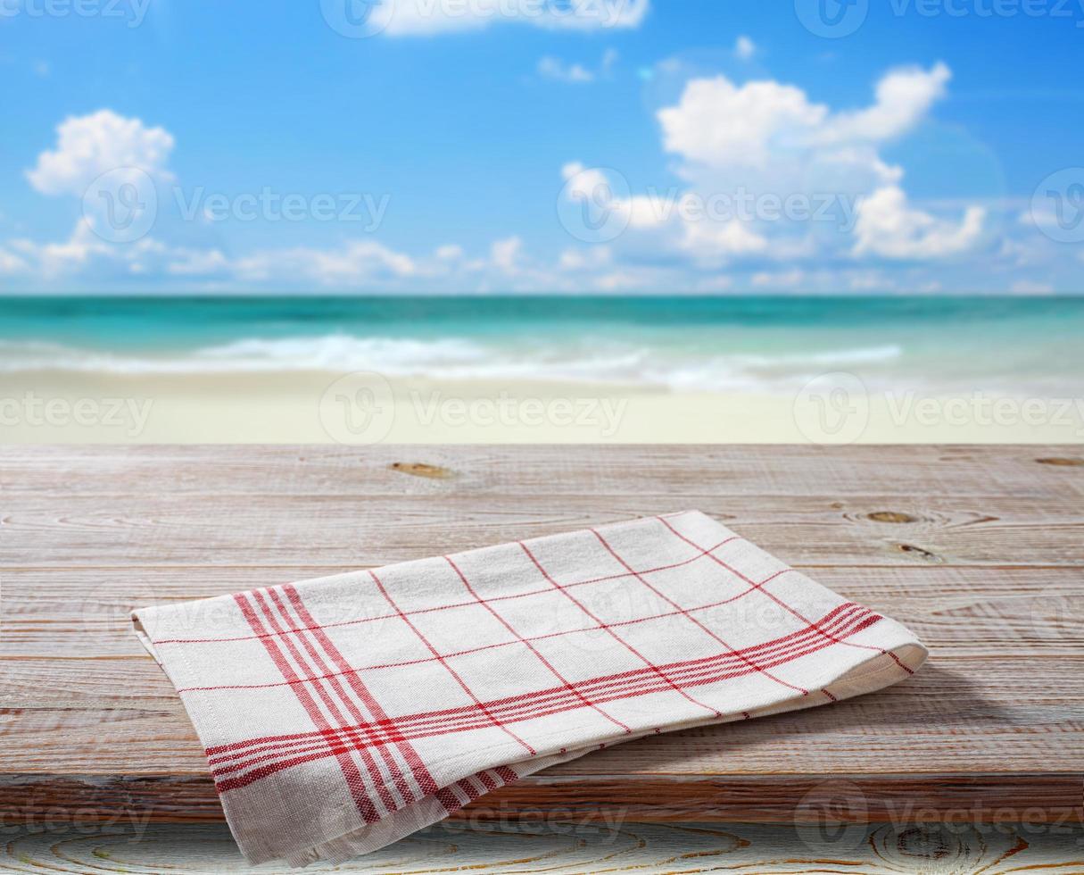 White napkin, table cloth on wooden deck mockup. photo