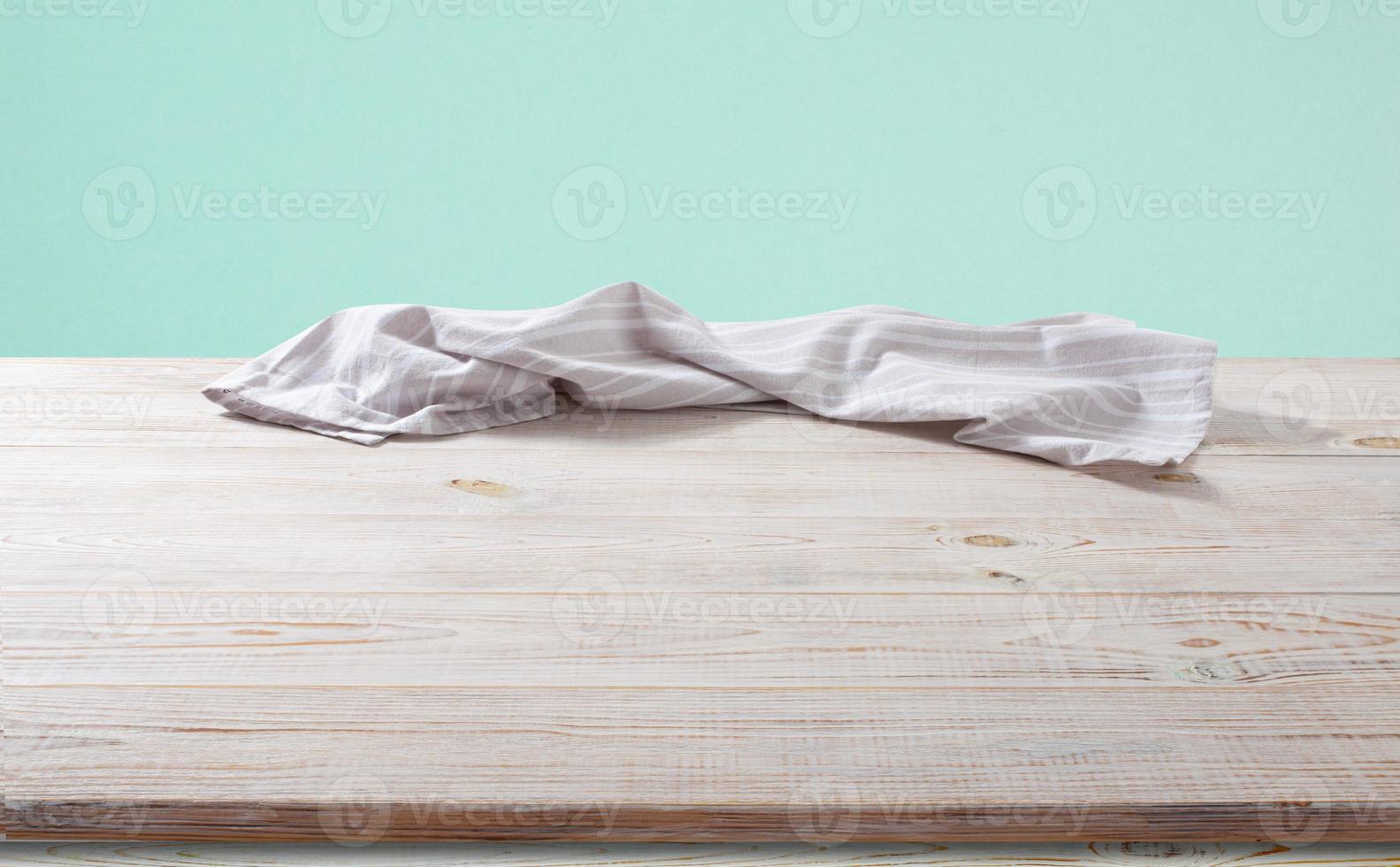 White napkin, table cloth on wooden deck mockup. photo