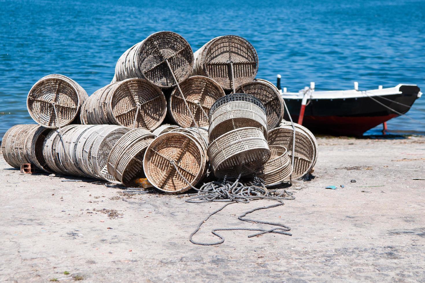 Pile of empty fishing cages. Boat on the water photo