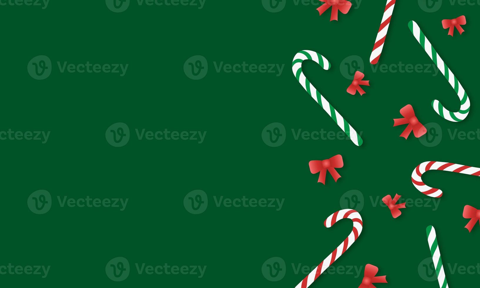 Green background with striped red and green candy canes and red bows with copy space photo