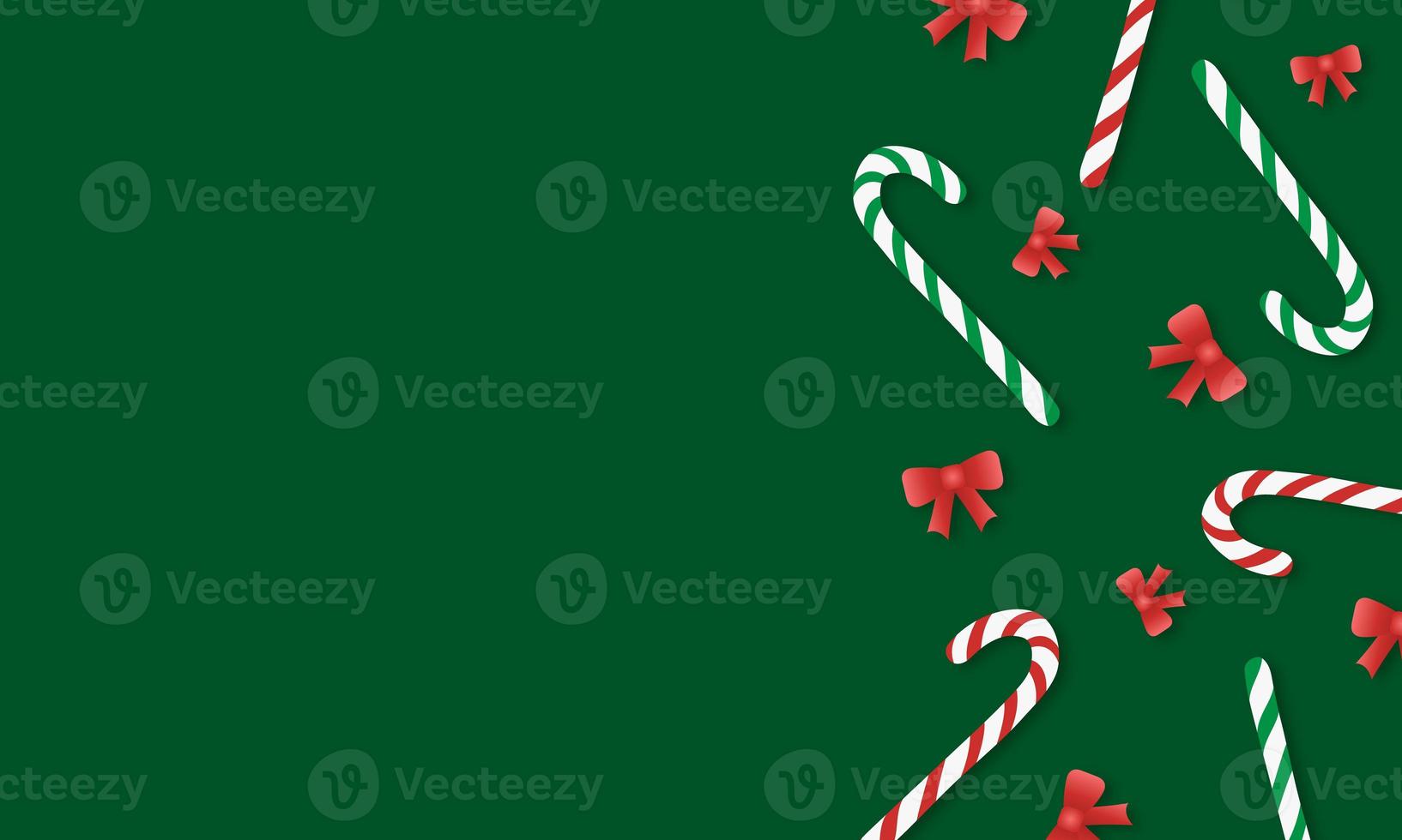 Green background with striped red and green candy canes and red bows with copy space photo