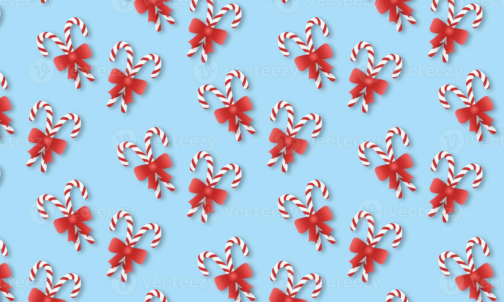 Repeating pattern of candy canes on a blue background photo
