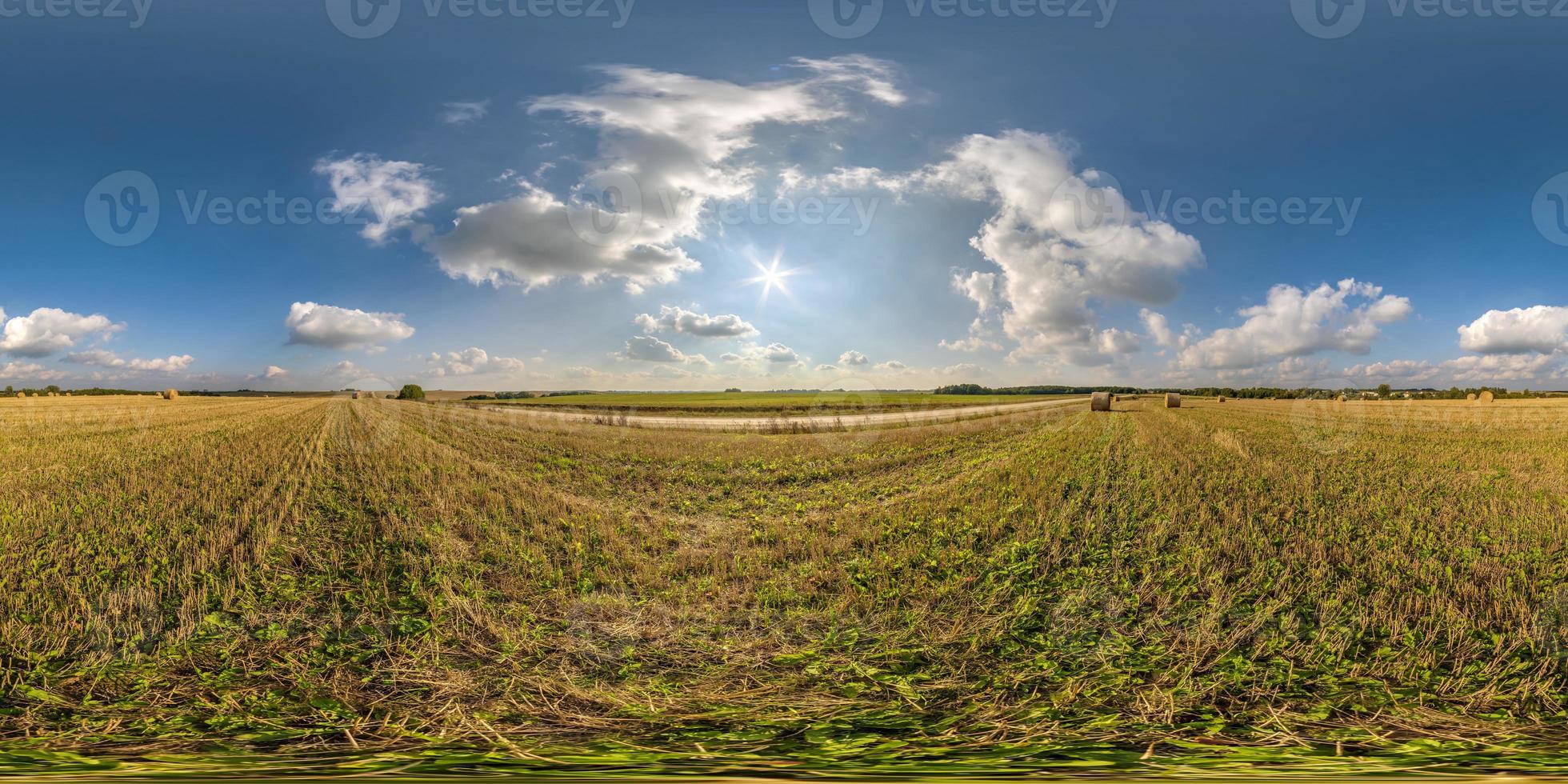 full seamless 360 hdri panorama view among farming field with sun and clouds in overcast sky in equirectangular spherical projection, ready for use as sky replacement in drone panoramas or VR content photo