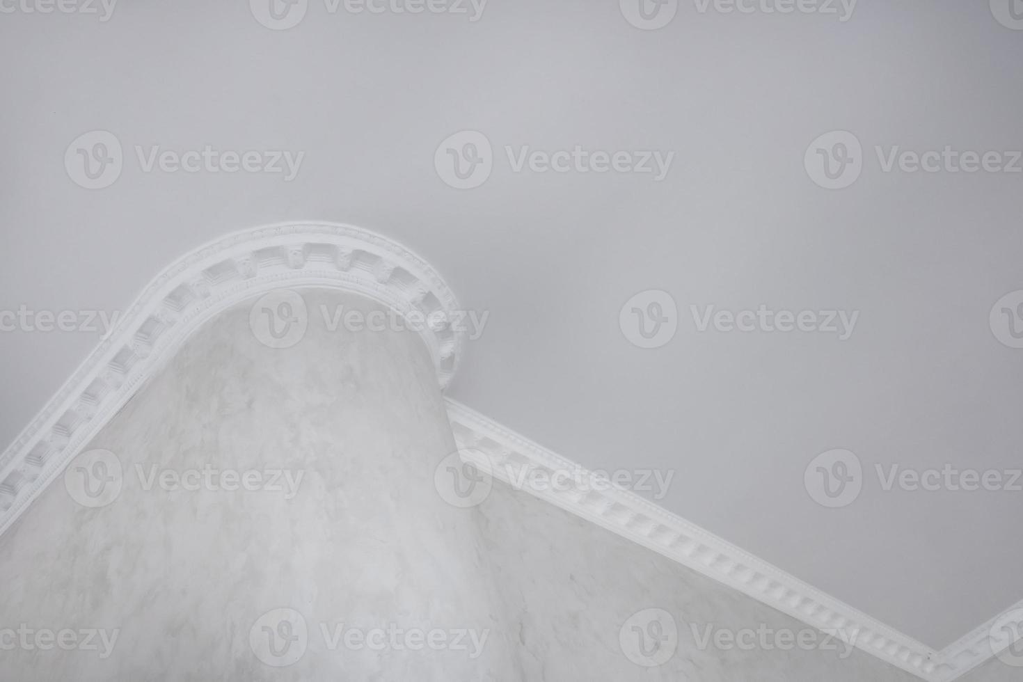 Detail of corner ceiling with intricate crown molding. photo