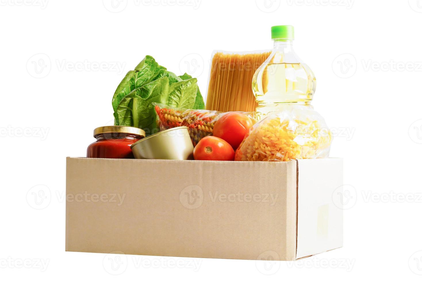 Foodstuffs in donation box isolated on white background with clipping path for volunteer to help people. photo