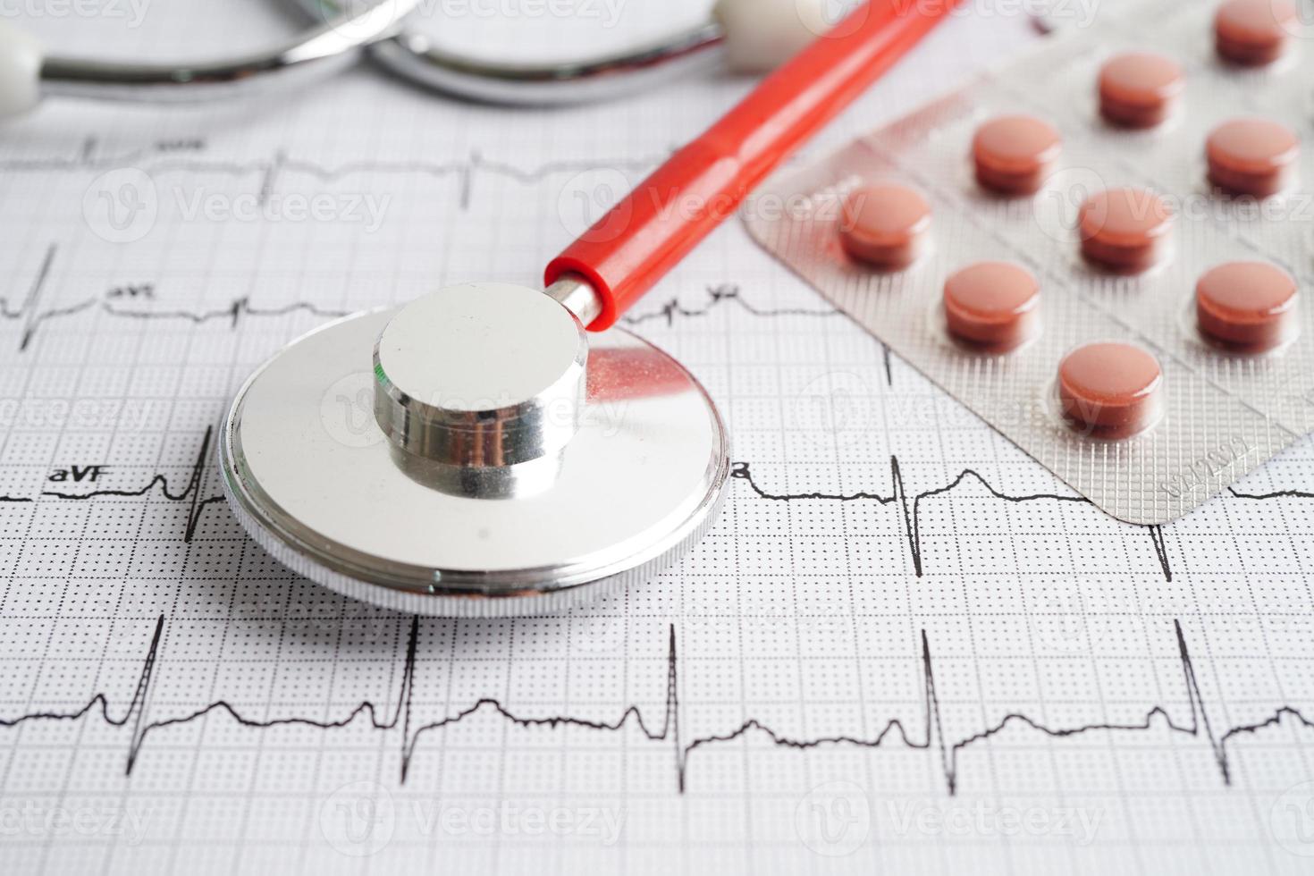 Stethoscope on electrocardiogram with drug, heart wave, heart attack, cardiogram report. photo