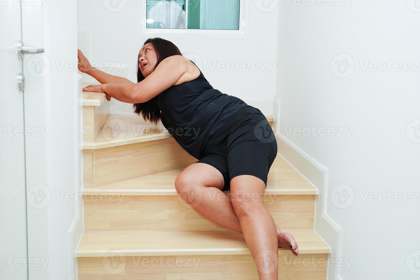 Asian business woman pain ankle, foot with leg cramp and fall down the