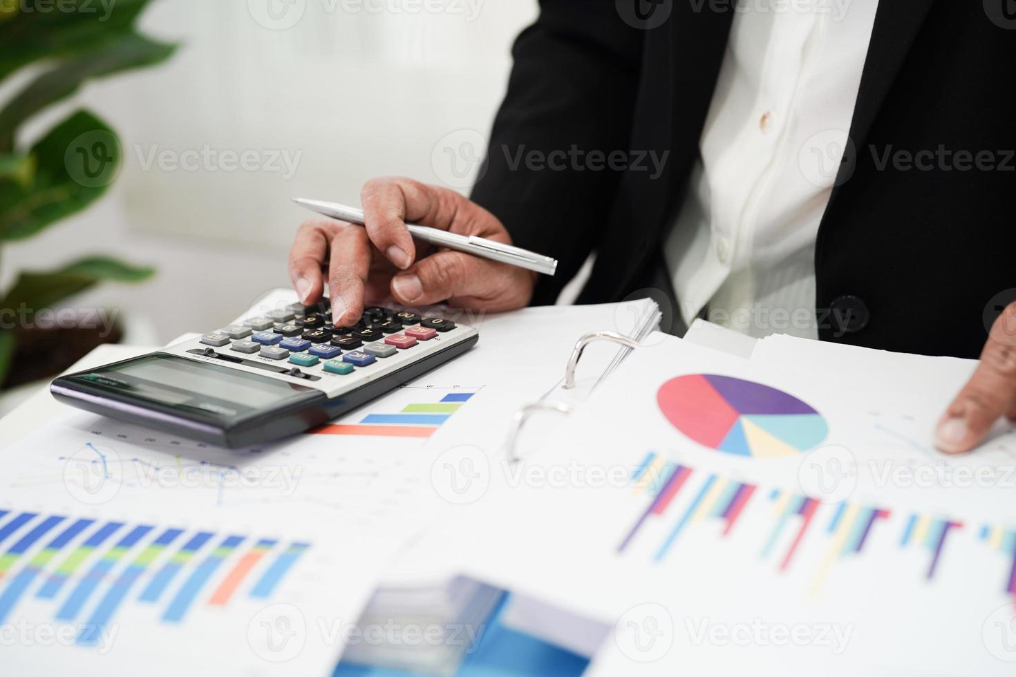 Business woman working and analysis with statistic graph in office. photo