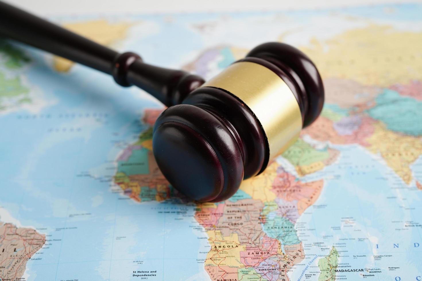 Bangkok, Thailand - May 15, 2022 Judges gavel on world map. photo