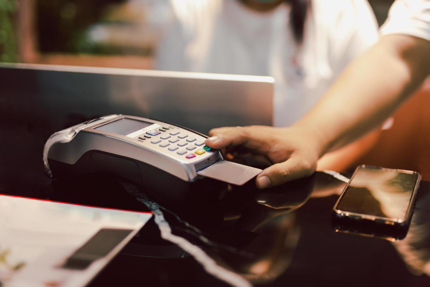 Man using credit card reader to enter PIN code photo